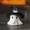 Black and purple resin wizard hat holiday ornament on a festive background.