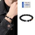 Black obsidian prayer wheel bracelet for men with a hand-woven silver clasp on a wrist.