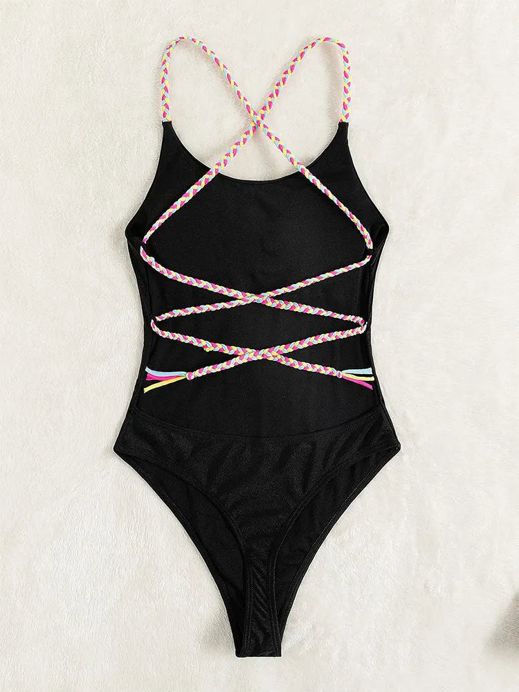 Black backless one-piece swimsuit for women on a mannequin, sleeveless design.