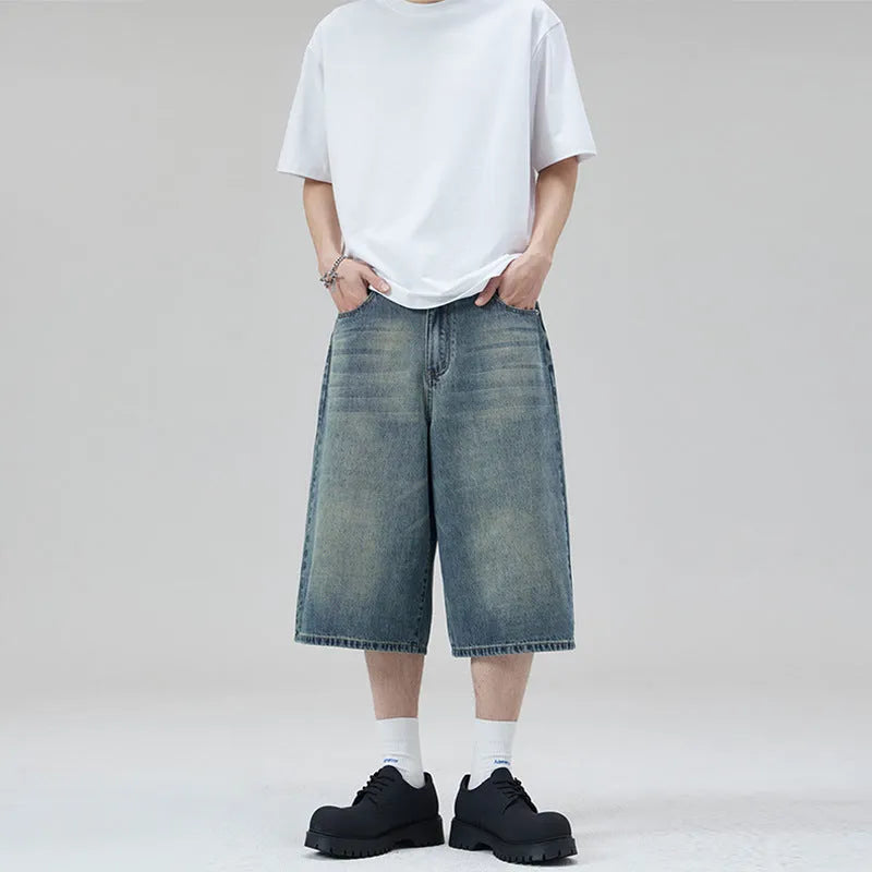A pair of light blue denim shorts with a loose straight leg and cropped length on a neutral background.