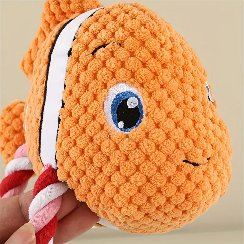 Turtle-shaped plush dog toy with knotted interior and squeaker in grey, green and orange colours