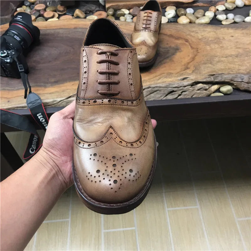 Men's light brown vintage distressed leather shoes with engraved detailing and round toe.