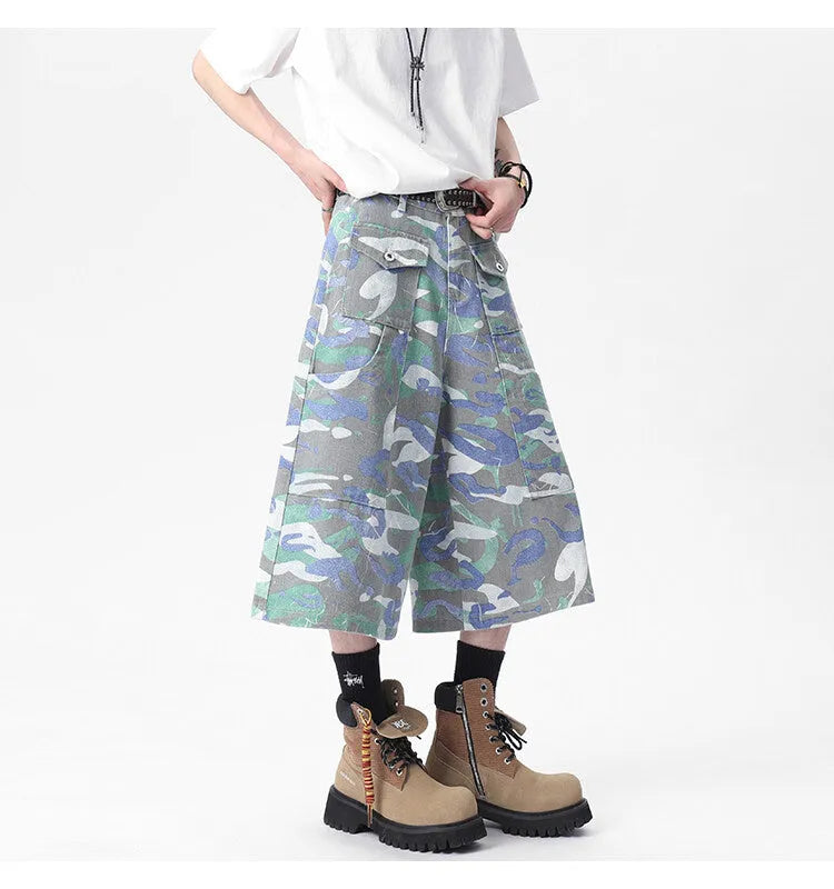 Women's cropped camouflage denim cargo trousers with a pocket on the leg.