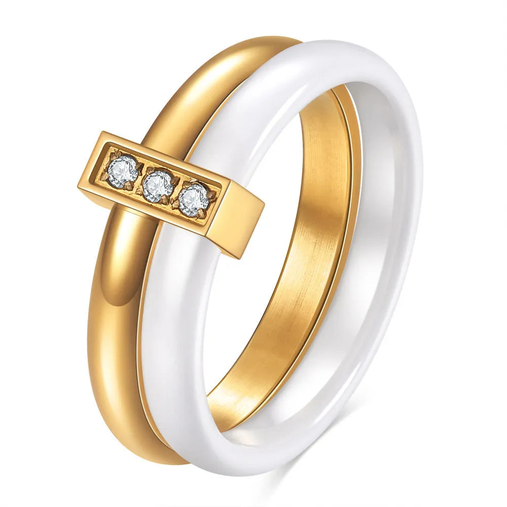 Glossy stitch and zirconium inlay ceramic ring for women in gold white on a geometric band.