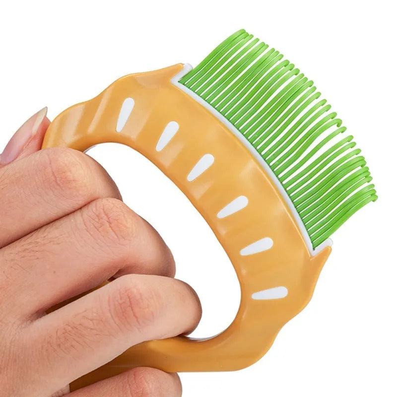Green shell-shaped pet grooming comb with bent wire bristles and an anti-slip plastic handle.