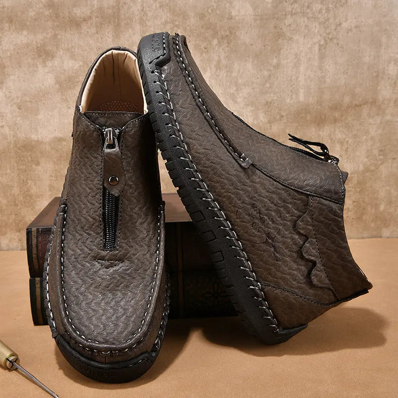 Men's black slip-on leather loafers with round toe and rubber sole, displayed on a white background.