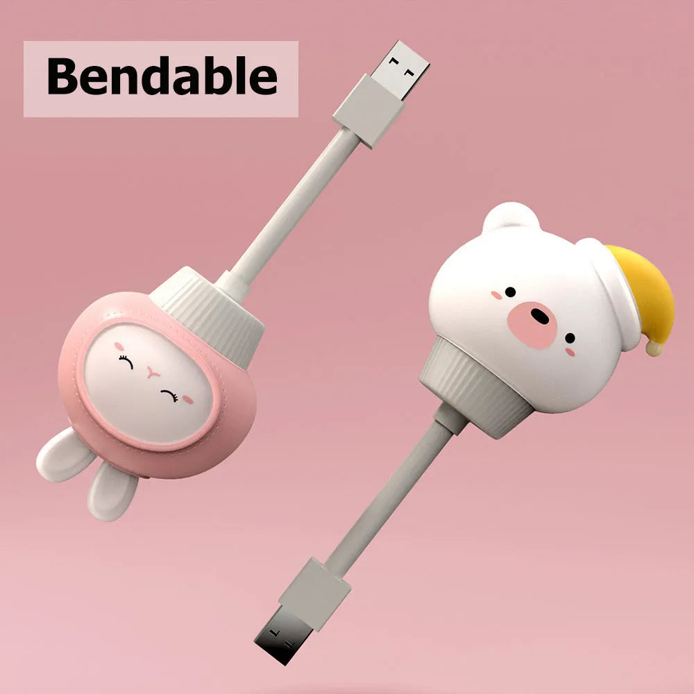 Cute cartoon animal USB night light in bear shape with remote control on a bedside table.