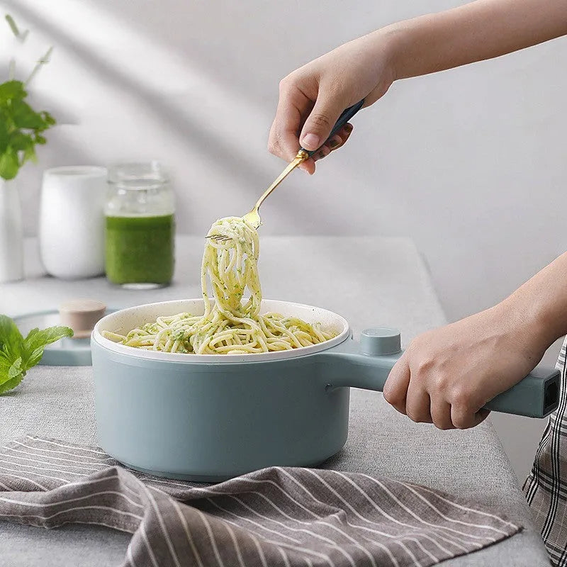 White mini electric cooking pot with 600W power and multiple cooking functions including boiling, steaming and frying