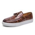 Men's brown tassel sneakers with round toe and rubber sole on a white background.