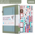 A5 notebook with PU leather cover in matcha green, lying open on a desk