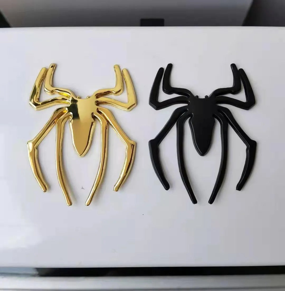 Three-dimensional metal spider car bumper sticker in gold, silver, black, and red colour options.