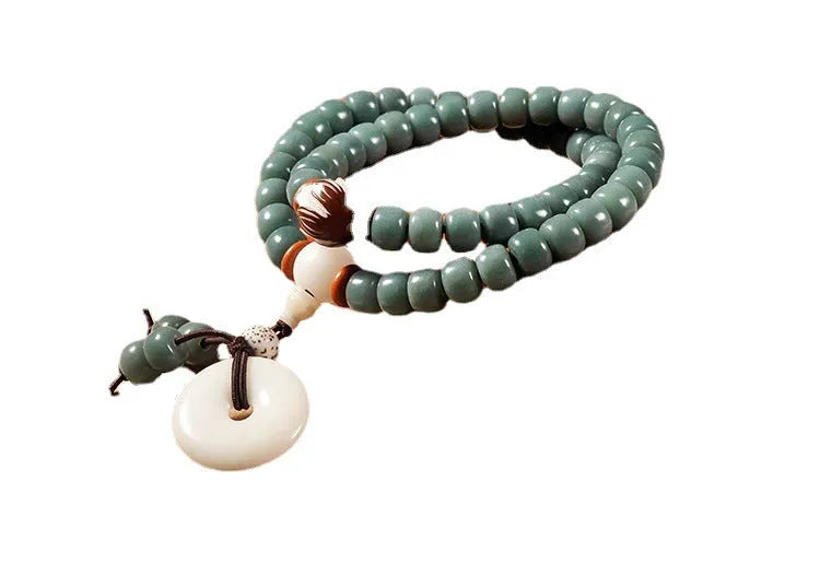 White jade green Bodhi seed bracelet with a safety buckle and lotus charm.