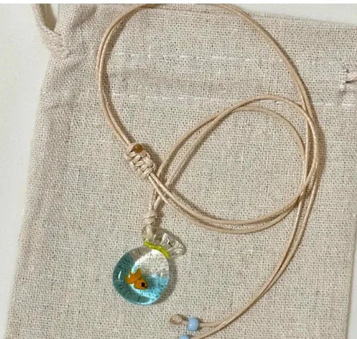 Women's necklace with coloured glaze skirt joker pendant on a beige cotton and linen chain, 45cm long.