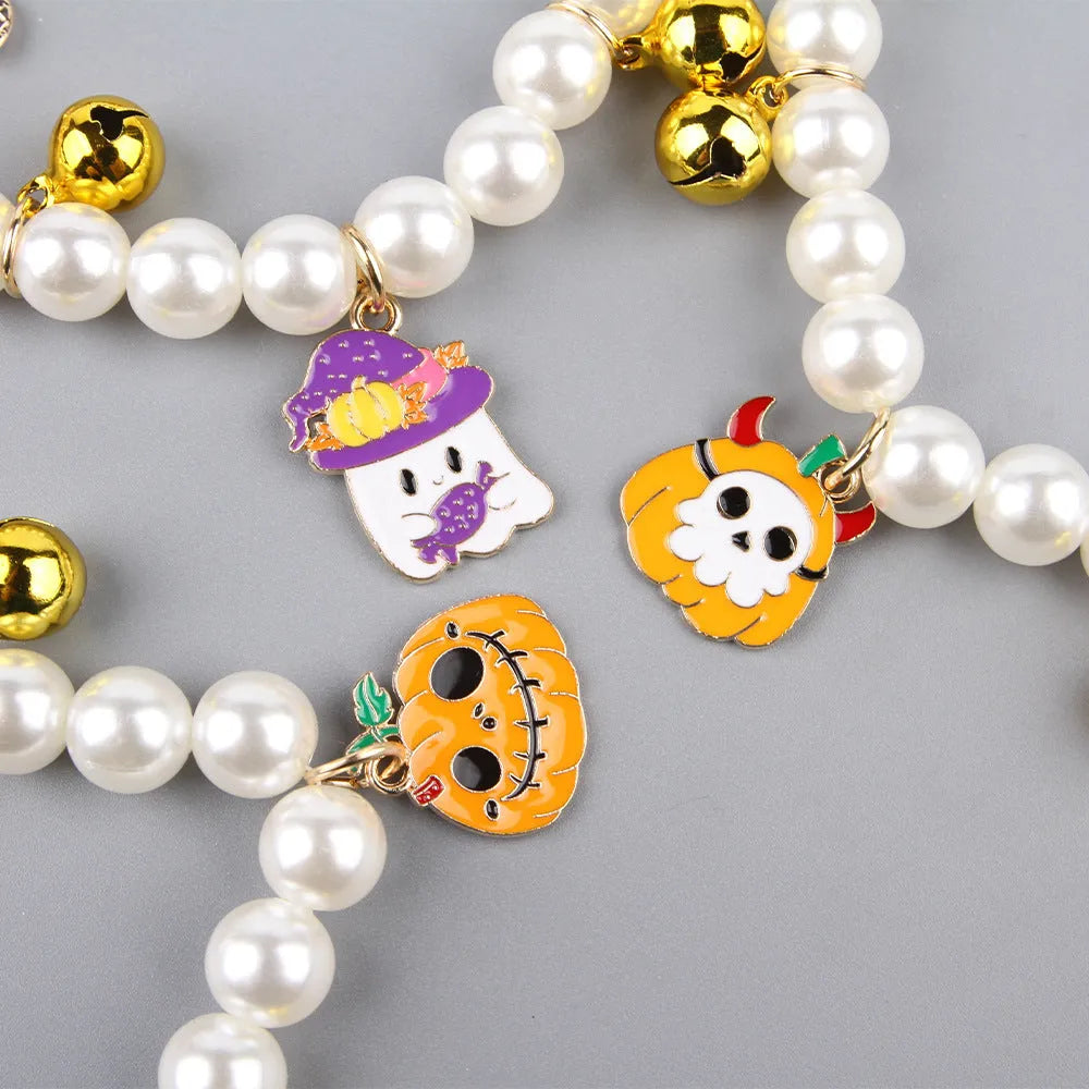 Halloween pet collar with simulated pearls and a purple ghost pumpkin charm around a cat's neck.