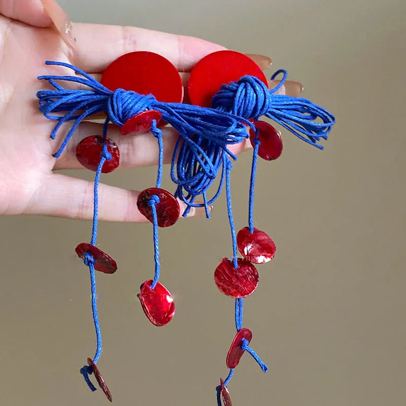 Women's geometric earrings with blue resin flower on textile base, circular shape