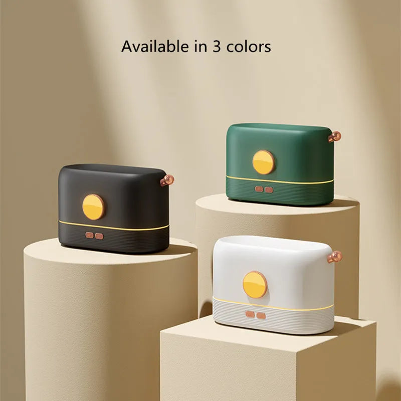 Black USB humidifier with simulated flame effect on a wooden desk.