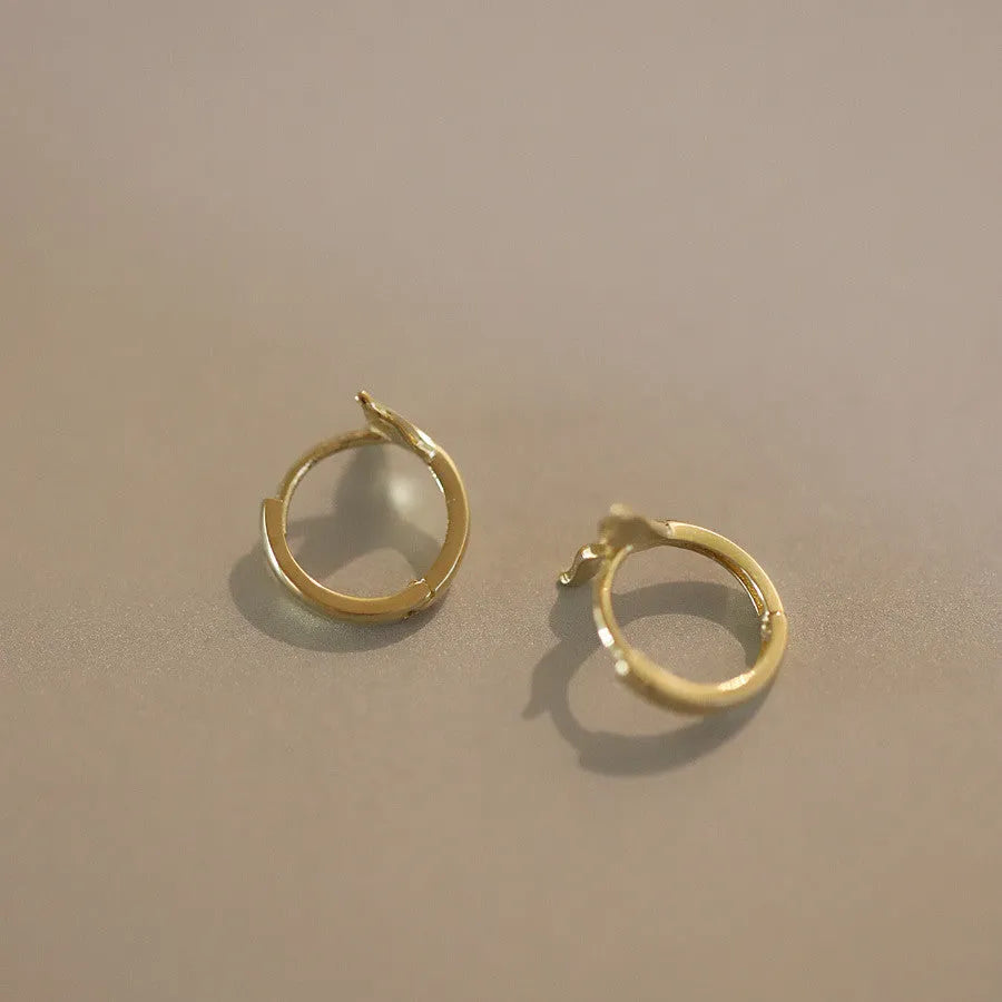 A pair of smooth fishtail earrings in gold colour, made from 925 sterling silver with 14k gold plating.