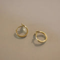 A pair of smooth fishtail earrings in gold colour, made from 925 sterling silver with 14k gold plating.