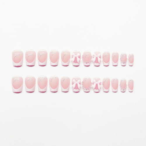 Short white French tip press-on nails with a cute pink bow design and a tulip pattern on a blush base.