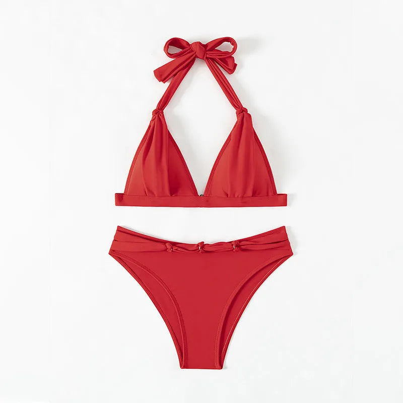Red women's lace-up halterneck bikini set with matching shorts