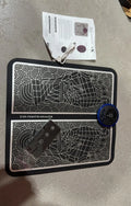 Pulse Micro-current leather foot massage cushions with remote control on a wooden floor.