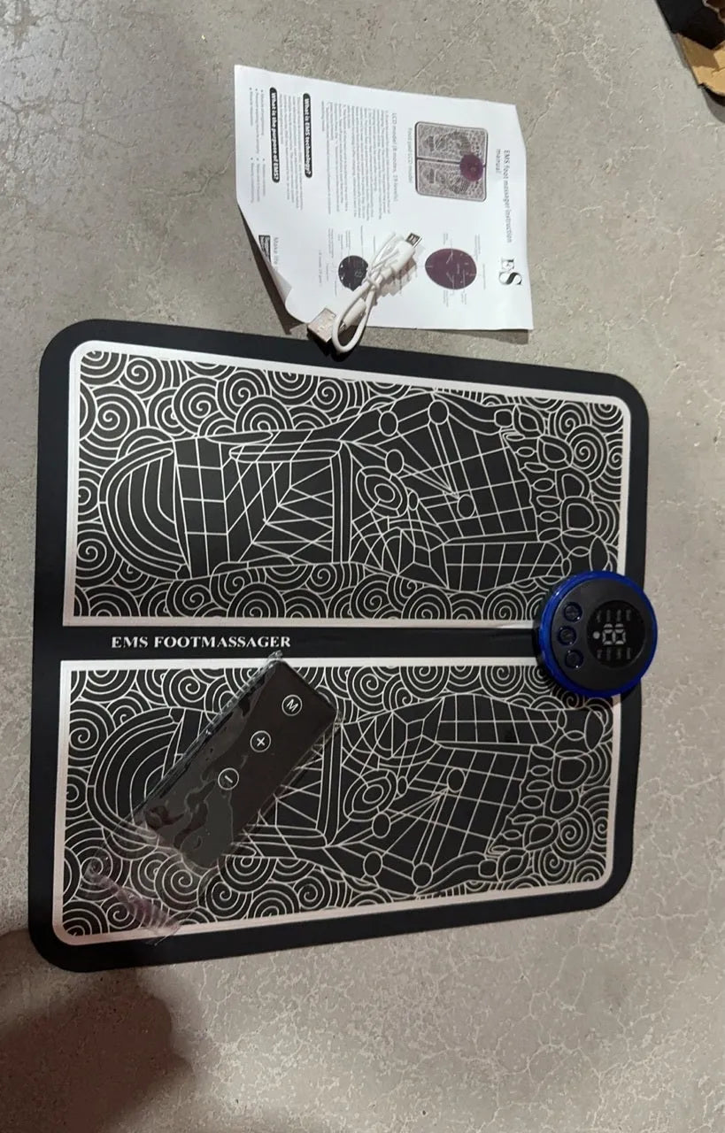 Pulse Micro-current leather foot massage cushions with remote control on a wooden floor.