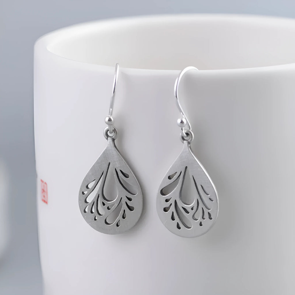 925 sterling silver hollow water drop retro earrings for women, showing grinding texture.