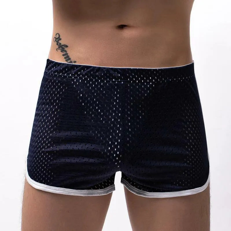 Men's grey cotton blend three-point boxer shorts laid flat, showing mid-waist design and knitted fabric texture.