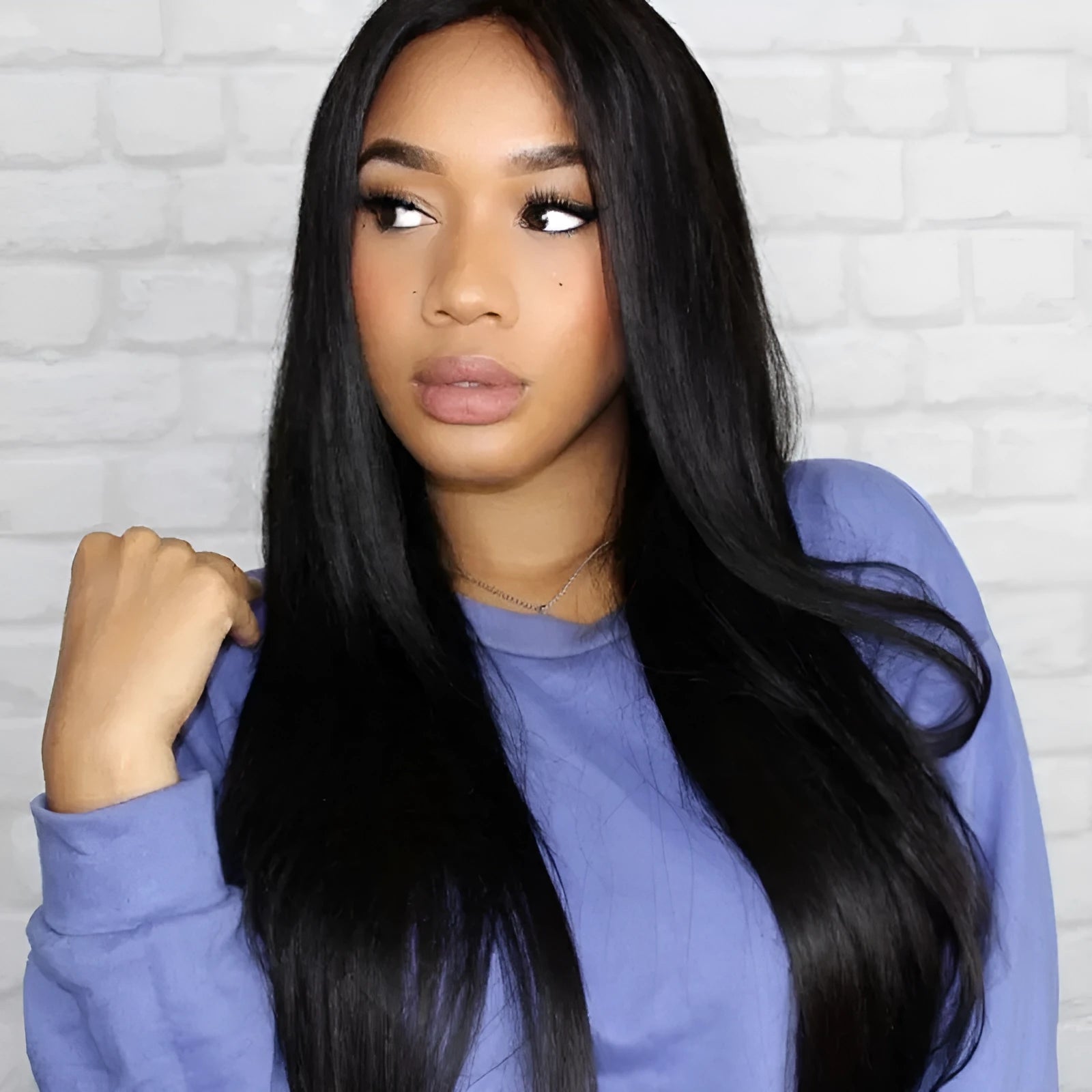 Women's long straight black synthetic wig with centre-part and bangs on a mannequin head