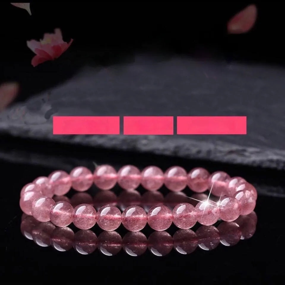 Women's adjustable bracelet with round, polished strawberry quartz crystal beads.