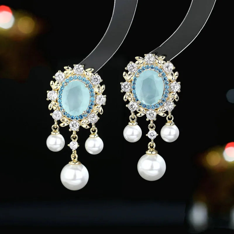 Oval geometric earrings with zircon inlay and tassel detailing in light purple colour
