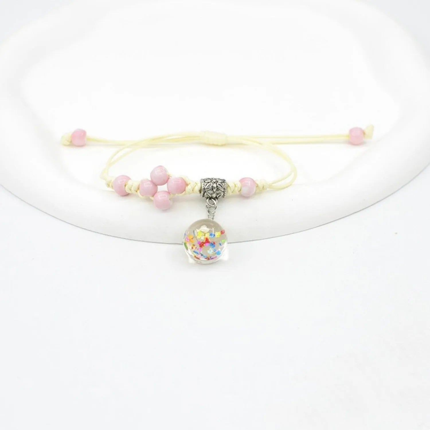 Hand-woven glass bracelet with large beads containing real dried flowers, shown in multiple colour options.