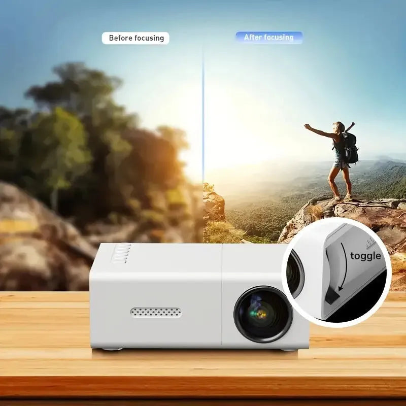 White or black M100 mini portable home projector with remote control on a table.