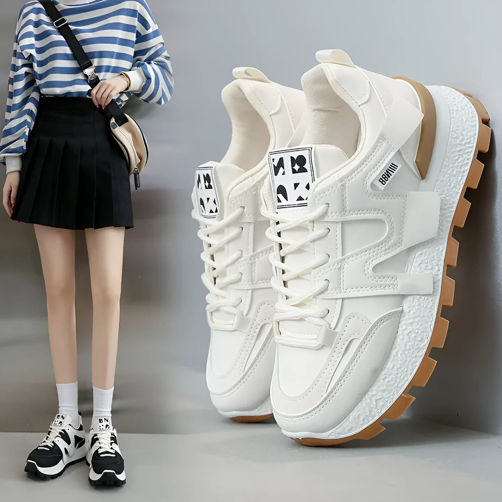 Women's low-top sneaker in black with artificial PU upper, rubber sole, and front lace-up closure.