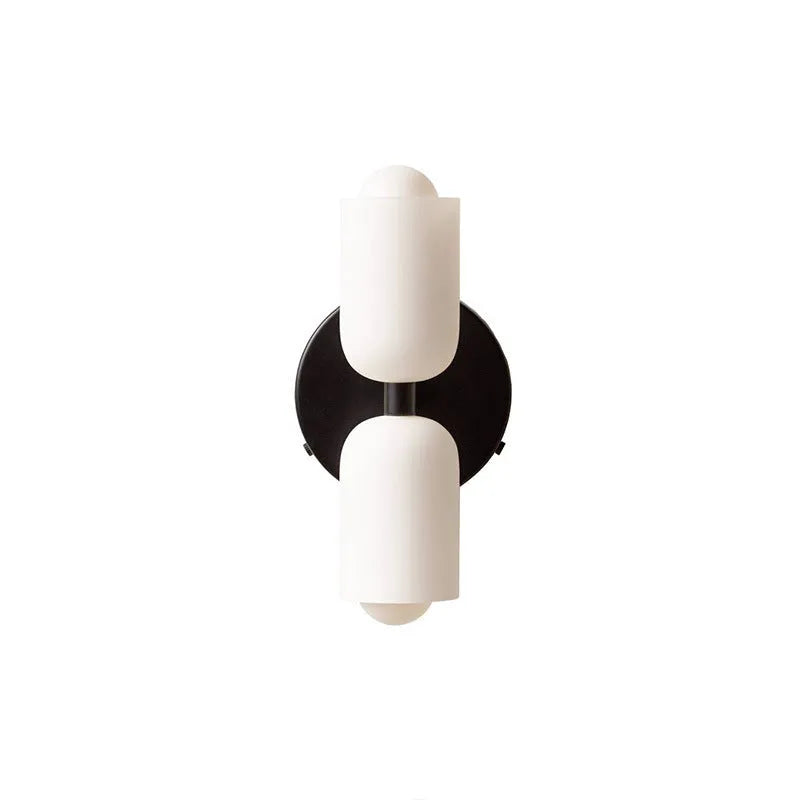 Cream base double head wall lamp with white glass shades against wall