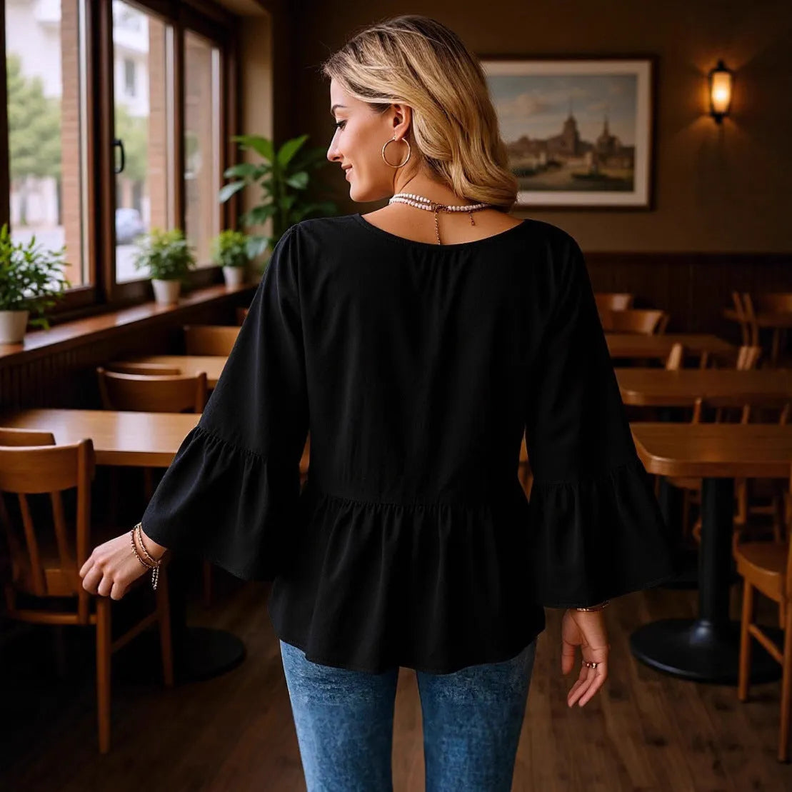 Women's solid black polyester shirt with seven-point flared three-quarter sleeves and pleated texture