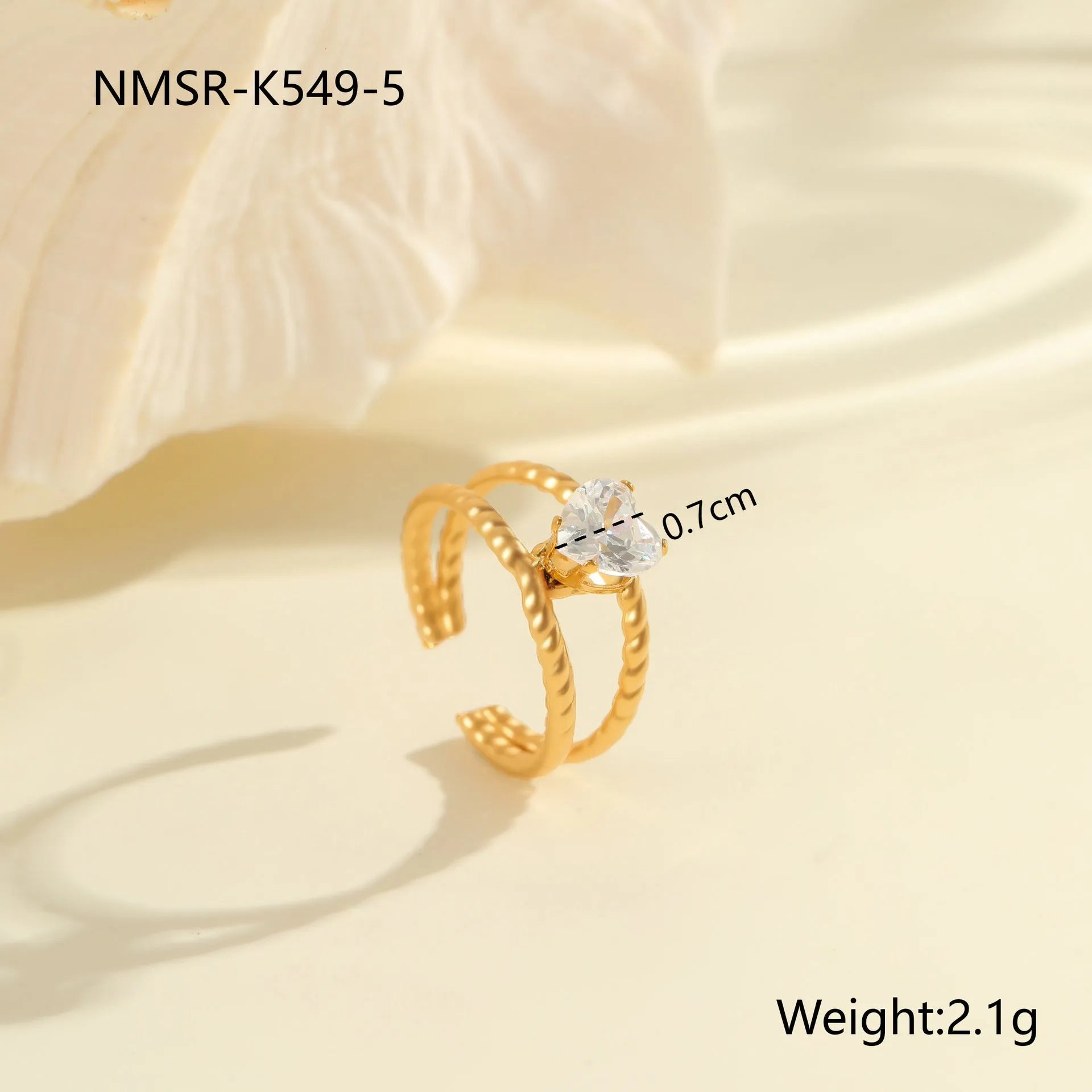 Gold electroplated adjustable ring with geometric zircon design on a stainless steel band.