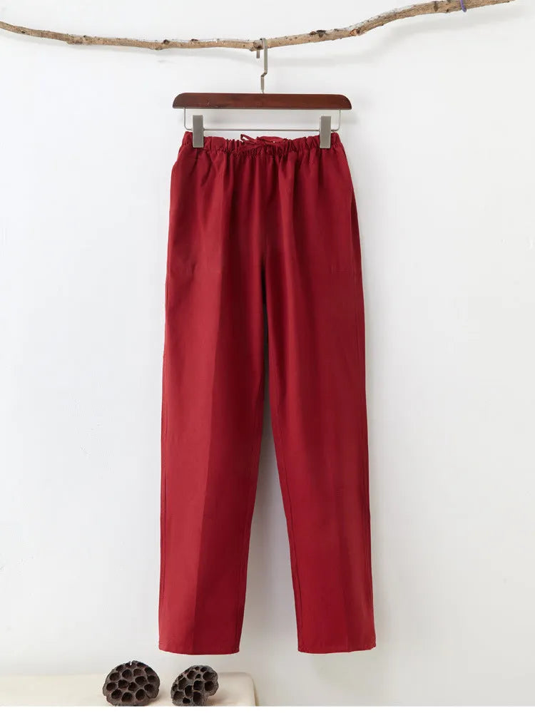 Men's beige pure cotton casual trousers with drawstring waist and belt on a neutral background.