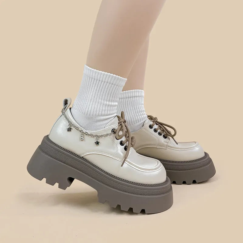 White platform Mary Jane shoes with a chunky block heel and front lace-up detail.