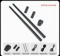 Black somatosensory air drum kit with wireless host unit, two drumsticks, and charging accessories on dark background