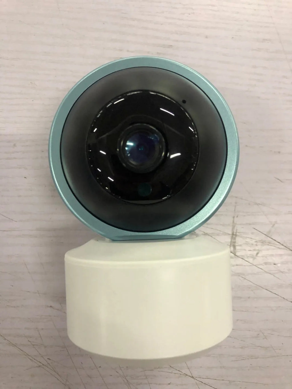 White indoor WiFi security camera with 360-degree rotation on stand showing 2MP resolution and optional memory card storage