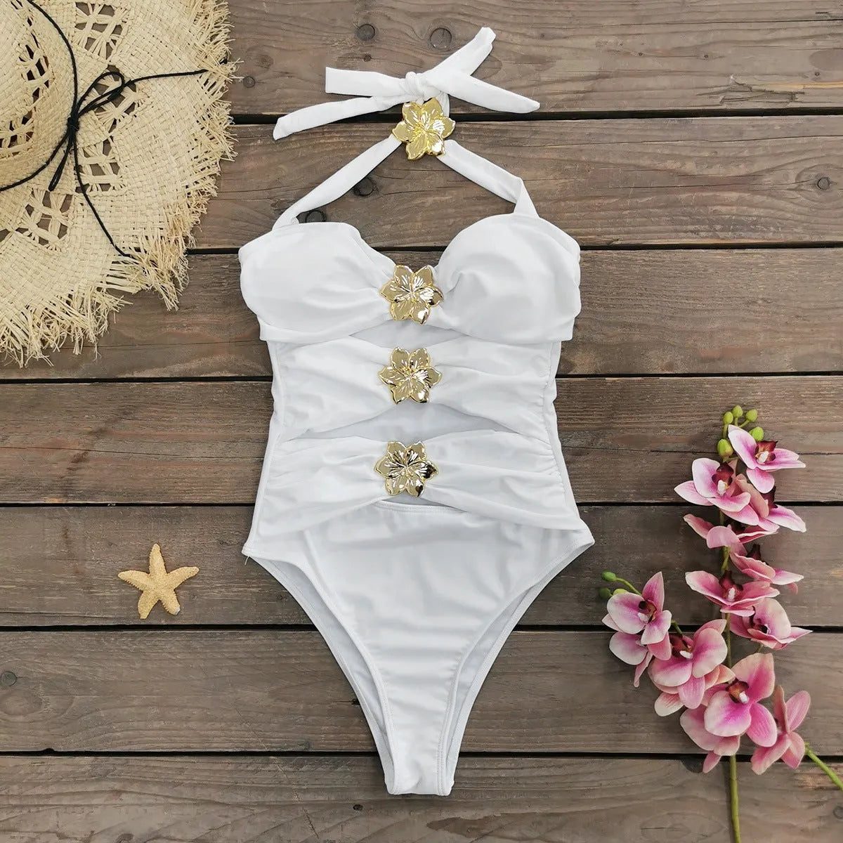 Women's solid colour one-piece swimsuit with hollow-out tube top and matching short skirt on hanger.