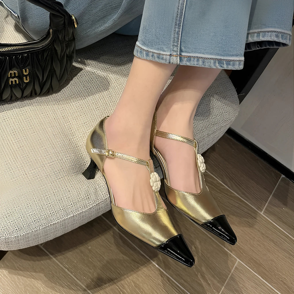 Women's gold stiletto shoe with flower decoration and buckle on sheepskin upper.