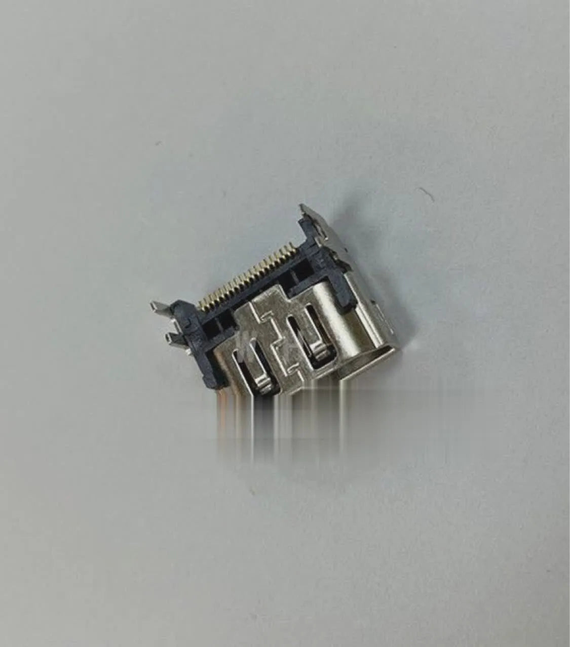 Silver coloured HDMI host socket interface for gaming console accessory.