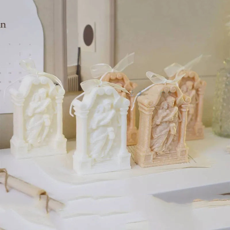 Flexible food-grade silicone mold for making hug angel couple figurines from wax, chocolate, or plaster.