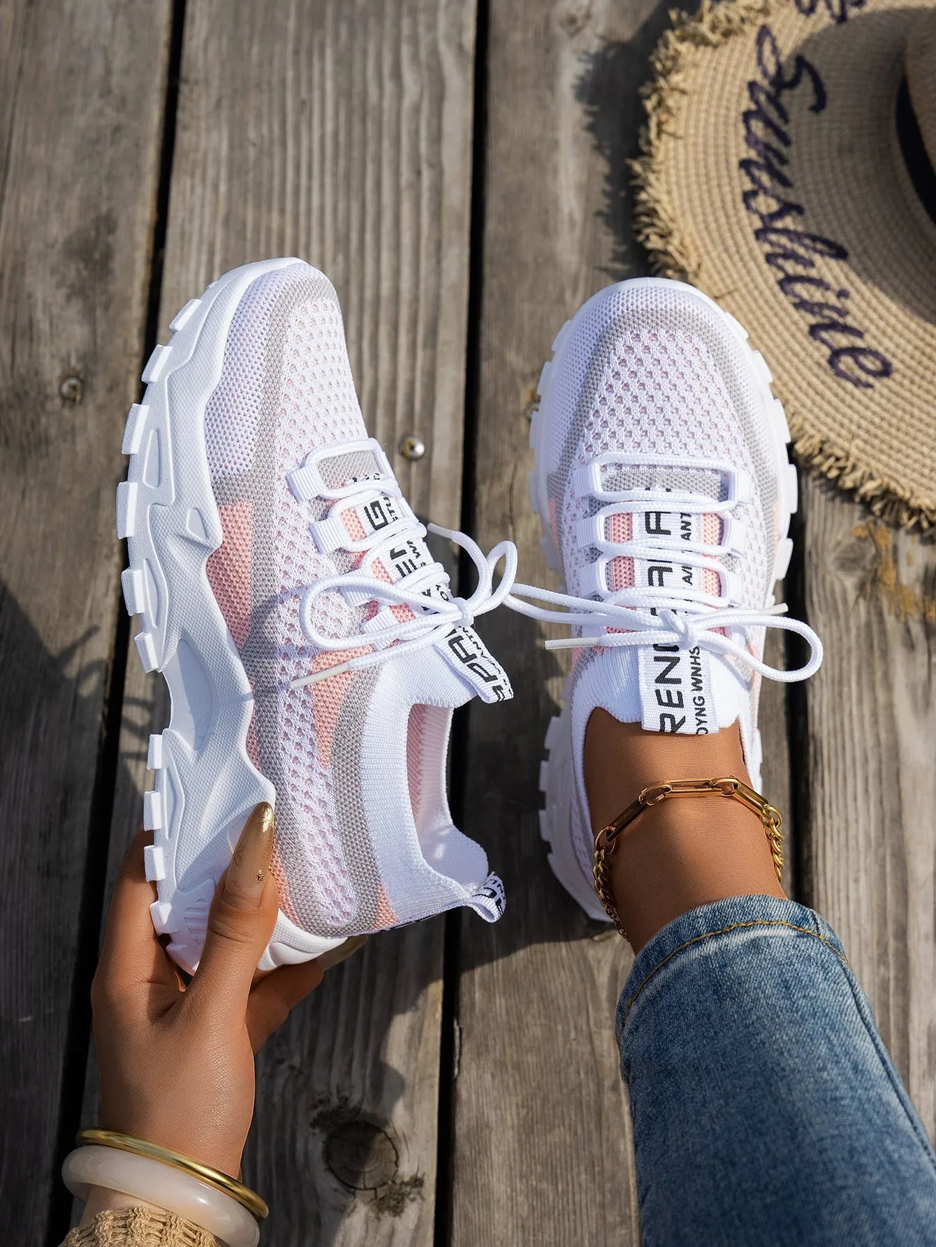 Women's Flyknit mesh lace-up sneakers in grey and white with a low rubber sole.