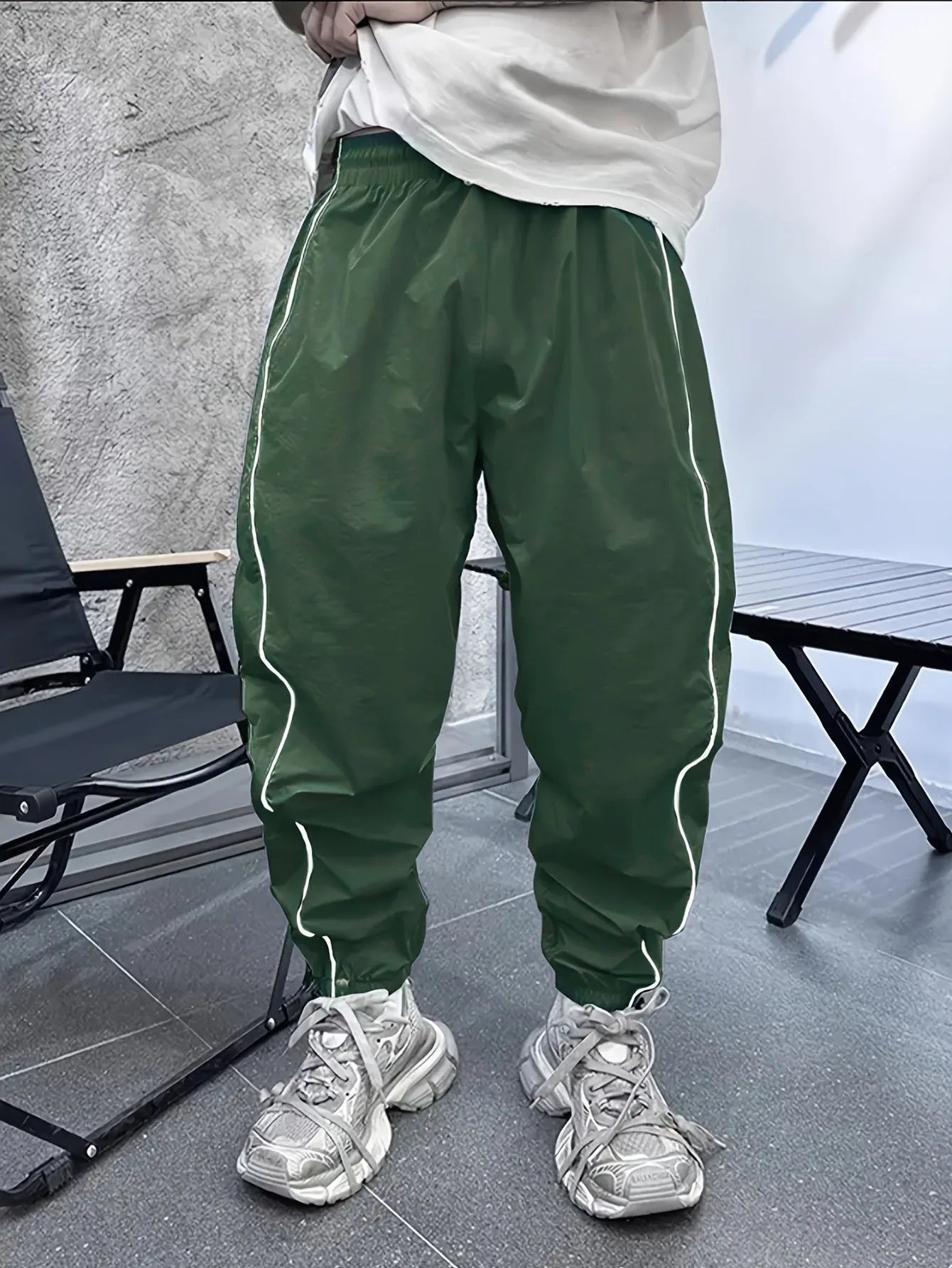Men's blue bamboo fibre casual sports trousers with cropped length and loose fit on a hanger.