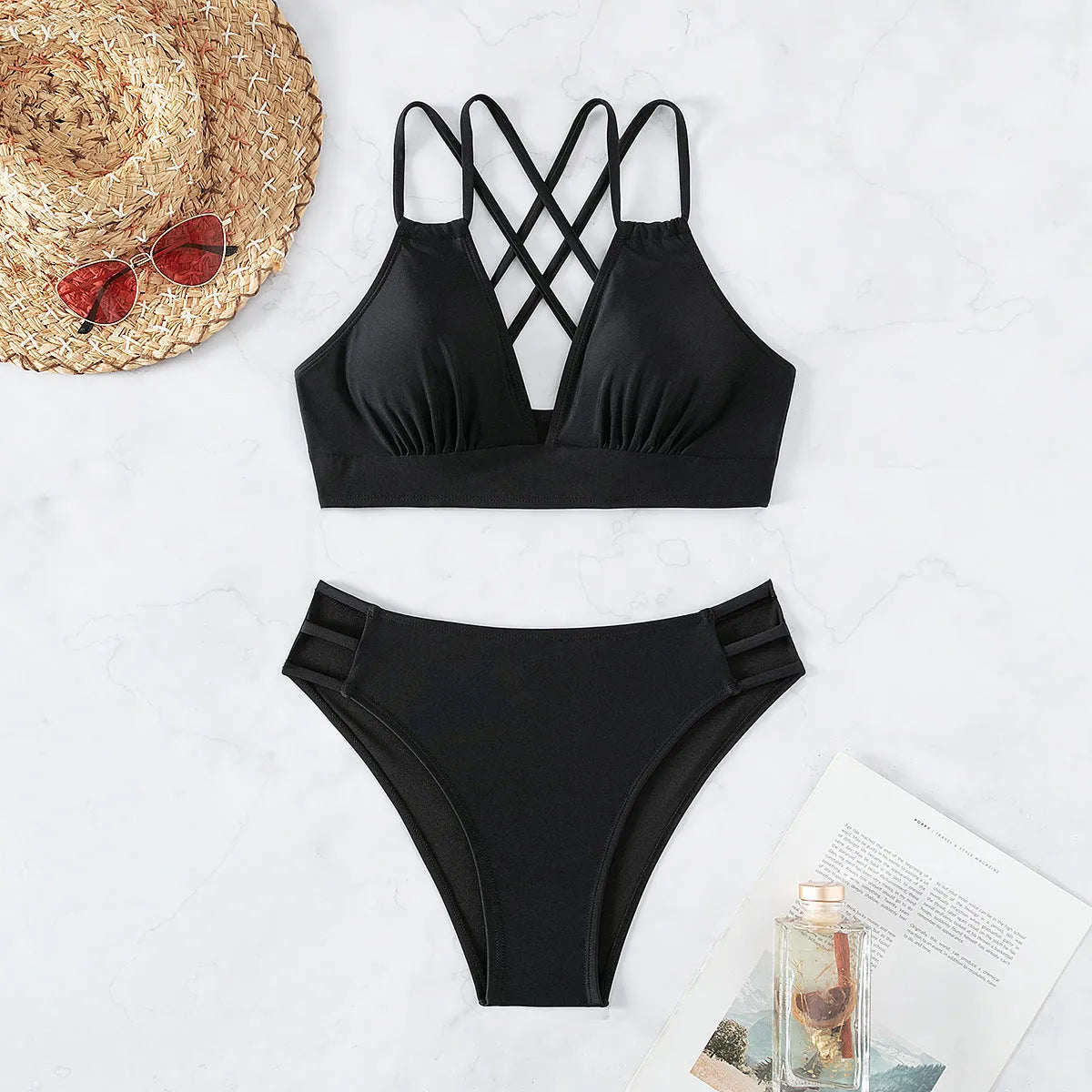 Women's black V-neck halter bikini top with split shorts on a mannequin.