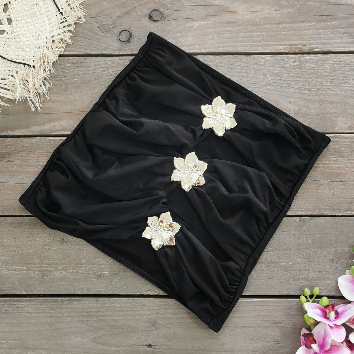 Women's solid colour one-piece swimsuit with hollow-out tube top and matching short skirt on hanger.