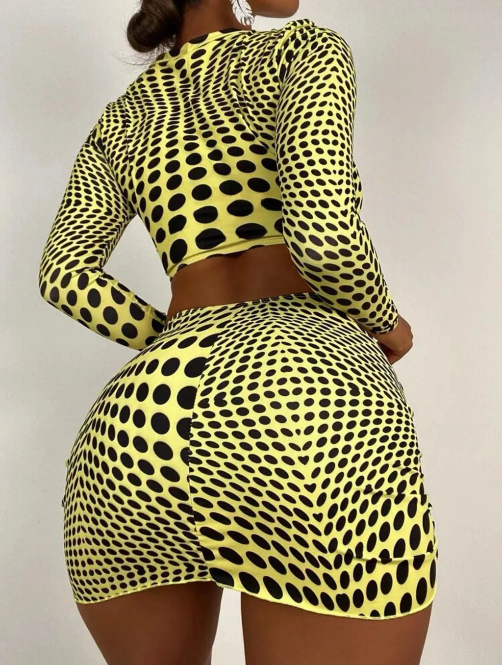 Green and yellow polka dot women's three-piece swimsuit set showing top, skirt, and bra.